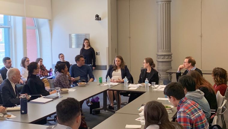 Candid shot of Furman Center representatives speaking at a NYU Wagner student event.
